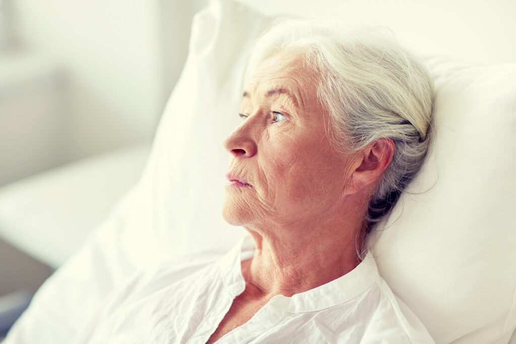 senior woman in bed in nursing home